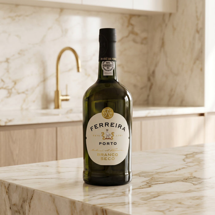 Bottle of Ferreira Porto wine on a marble countertop with a kitchen background