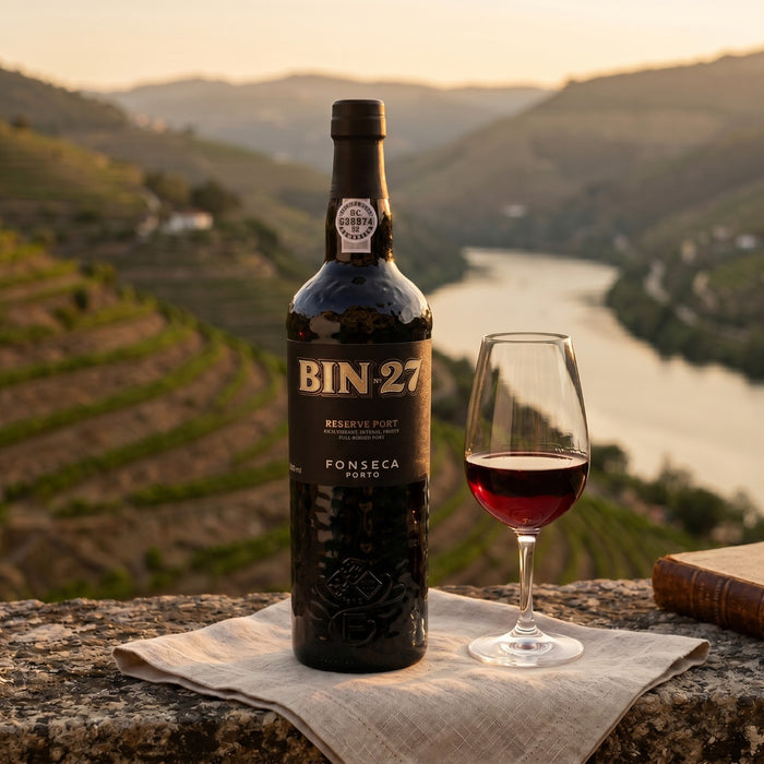 BIN 27 PORT bottle with a glass of red wine on a scenic background