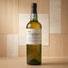 Bottle of Fonseca Porto Siroco wine on a wooden surface with a wooden paneled background