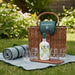 Grahams picnic hamper full set with basket, bottle of port, glasses, picnic rug and chopping board on grass