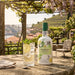 Graham's White Port bottle with a glass of lemonade in a scenic outdoor setting