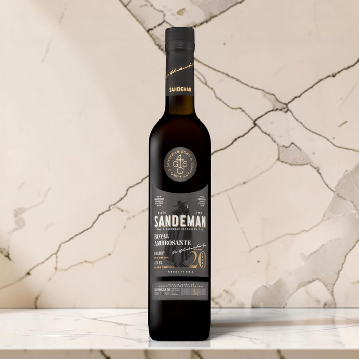 Sandeman Royal Ambrosante Pedro Ximenez 20 Year Old Sherry on a marble countertop.