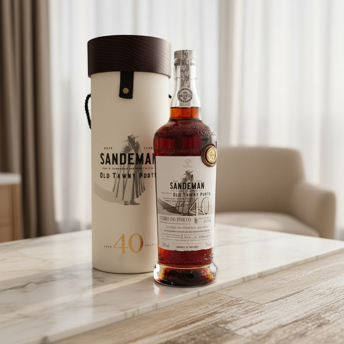 Bottle of Sandeman 40-year-old port wine with packaging on a marble surface.