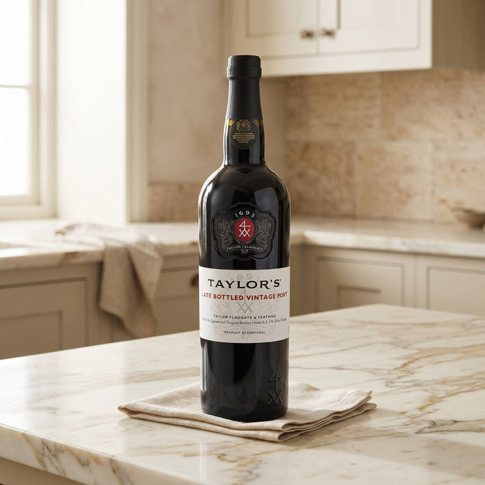 Bottle of Taylor's Port wine on a marble countertop in a kitchen.