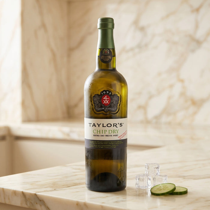Bottle of Taylor's Chip Dry white port wine on a marble surface with a blurred background