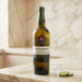 Bottle of Taylor's Chip Dry white port wine on a marble surface with a blurred background
